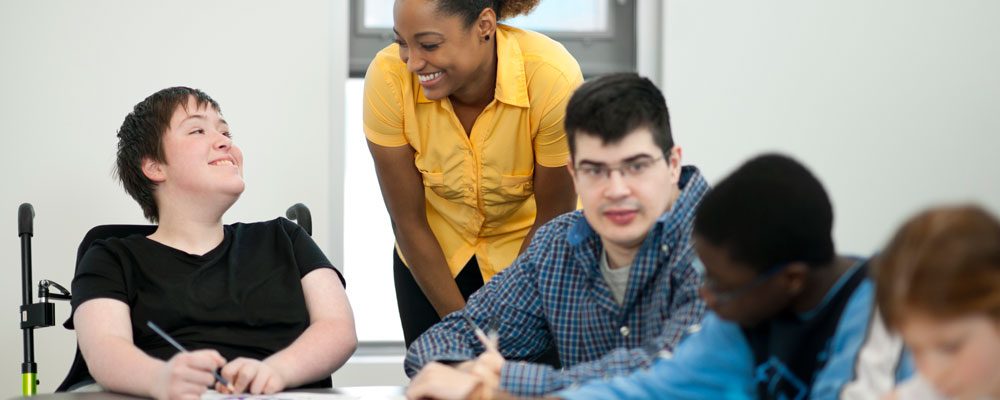 Teacher with Students: Special Education Transition to Adulthood Online Graduate Certificate